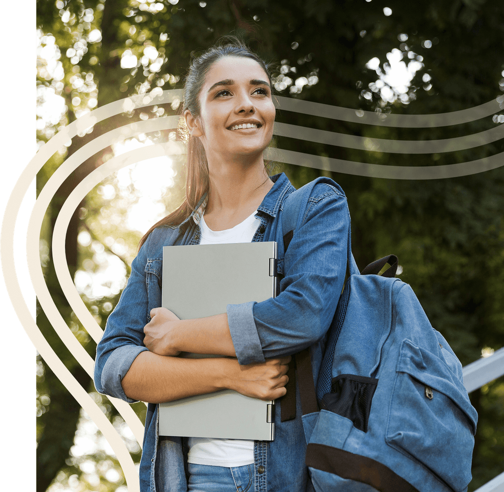 A learner carrying a laptop and backpack outdoors